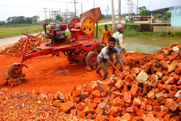 SYLHET, BANGLADESH - SEPTEMBER 18: Workers collect broken bricks for the crushing machine. Broken bricks will be used for road building and other types of construction construction. On September 18, 2022, Sylhet, Bangladesh. (Photo credit should read H M Shahidul Islam/ Eyepix Group/Future Publishing via Getty Images)